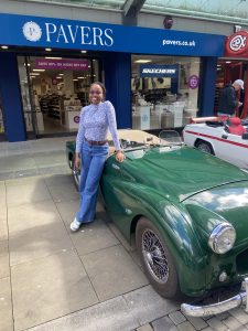 Haikaeli standing in front of a vintage car