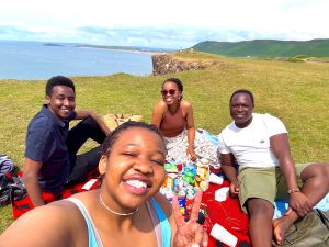 Scholars sharing a picnic by the sea.