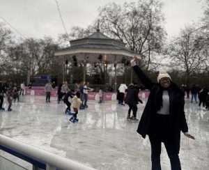 Woman standing using ice skates, skating on an ice rink.